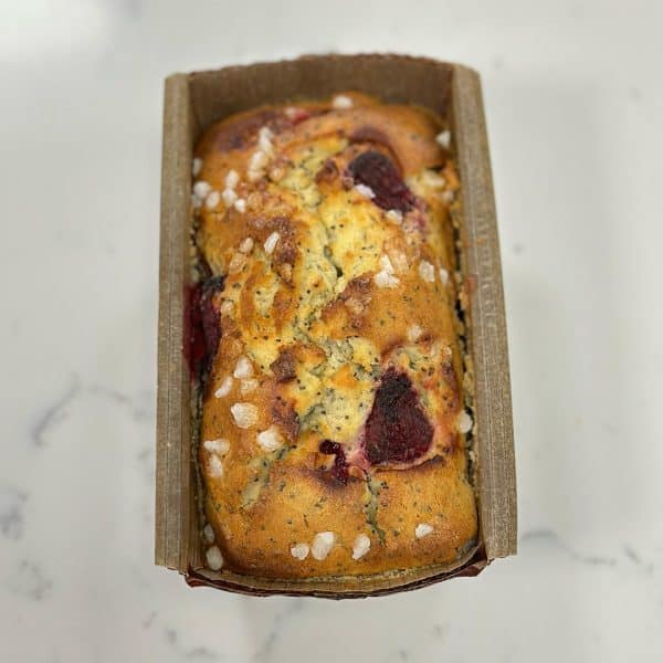Poppyseed bread with lemon zest and fresh raspberry, topped with rock sugar